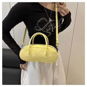 Detail of light yellow PU leather Boston bag with silver zipper and detachable strap
