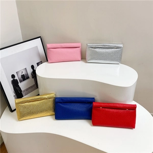 Colorful woven envelope clutch bags in pink, silver, gold, blue and red on white display