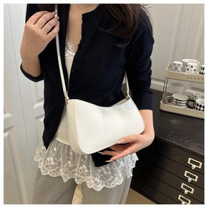 Detail of white half-moon shoulder bag in smooth synthetic leather with gold buckle
