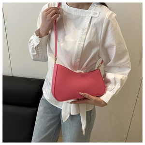 Detail of pink crescent hobo bag styled with a white shirt and blue denim jeans