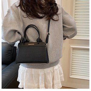 Chic black crocodile embossed crossbody bag with Fashion Bag lettering and metal handles