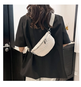 Rear view of cream white crescent chain bag styled on a casual black t-shirt