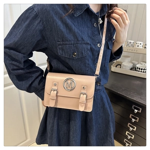 Fashionable crossbody square bag in dusty pink with metal M logo and strap detail