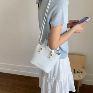 White fashion bucket bag in oil wax leather with gold studs and crossbody strap for women