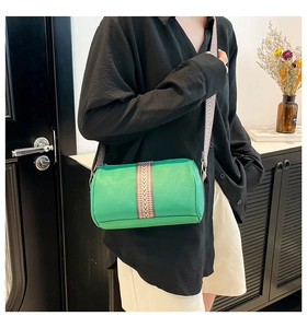 Green leather barrel bag detail featuring lychee texture and ethnic geometric wide strap