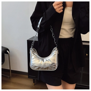 Close-up of silver hobo bag featuring metallic finish and fashion letter branding
