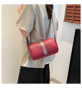 Detail showing red Boston bag with litchi leather and geometric shoulder strap