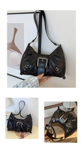 Detail of glossy black motorcycle shoulder bag featuring a large silver metal buckle