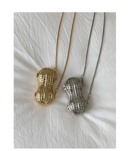 Close-up of peanut-shaped necklaces in gold and silver finish with crystal pavé