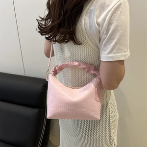 Pink ruffled handle crossbody bag in glossy pleated leather with slim shoulder strap