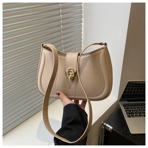 Detail of warm apricot shoulder bag showing gold ring buckle and matte leather texture
