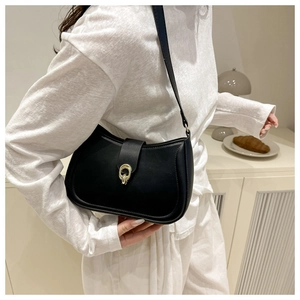 Detail of black matte leather hobo bag featuring elegant golden oval buckle and strap
