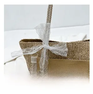 Detail of woven straw tote bag with HELLO canvas pocket and lace bow decoration
