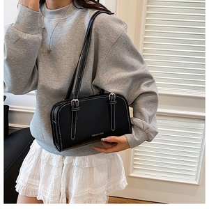 Detail of black shoulder bag with white contrast stitching and Fashion & Bag lettering