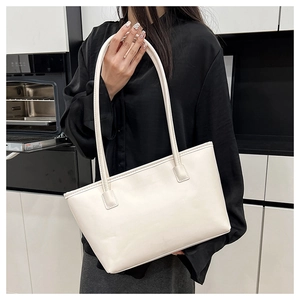 Detail of minimalist cream-white large capacity tote bag with smooth synthetic leather texture