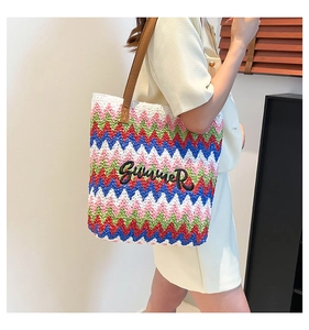 Close-up of rainbow striped woven tote bag with Summer embroidery and leather straps