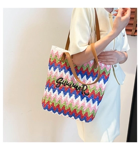 Close-up of colorful wave woven tote bag with Summer embroidery and leather straps
