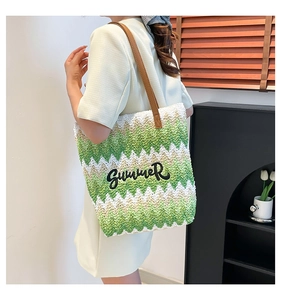 Detail of woven tote bag with green zigzag pattern and black Summer embroidery