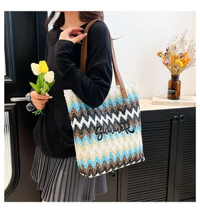 Close-up of summer straw tote bag with colorful wave patterns and Summer embroidery