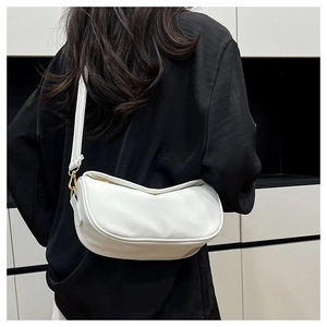 Detail of white lychee texture leather crescent bag with adjustable golden hardware buckles