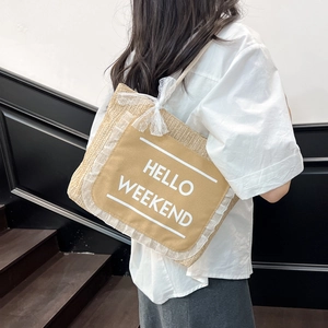 Woven straw tote bag with Hello Weekend print and lace bow in casual summer style