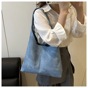 Close-up of a light blue large tote bag featuring premium stone texture on PU leather