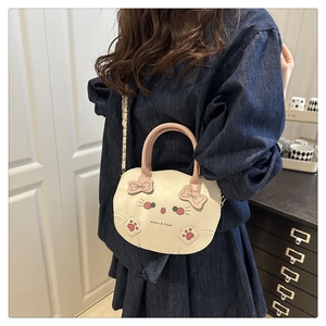 Detalle de bolso bandolera de gato con asa rosa y correa de cadena metálica
