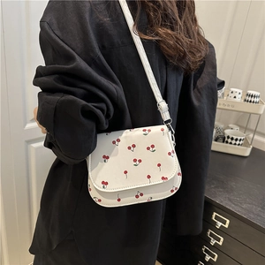 French style underarm bag with red cherry print on white leather and long shoulder strap