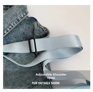 Detail of adjustable light blue shoulder strap with durable black buckle on canvas bag