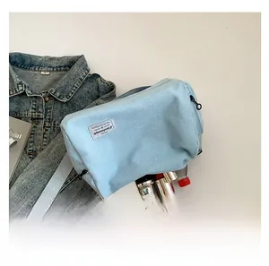 Flat lay showing large capacity of the light blue canvas bag with daily essentials