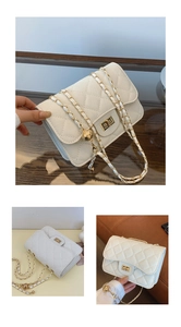 Detail of beige quilted leather mini bag with gold chain strap and metal ball adjuster