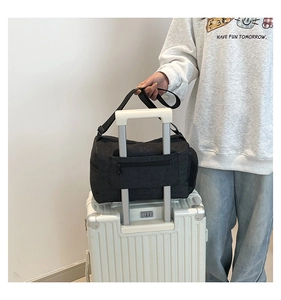Detail of travel tote bag with trolley sleeve attachment for suitcase luggage handle