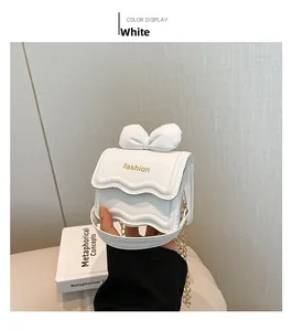 Vue détaillée du mini sac à main blanc avec nœud décoratif et chaîne dorée