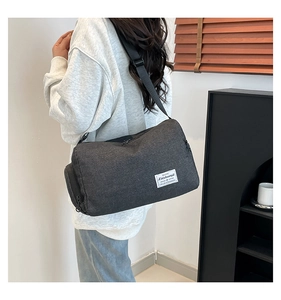 Detailed side view of dark grey casual crossbody bag with adjustable wide strap