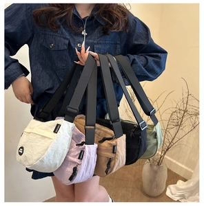 Collection of nylon dumpling cross-body bags in various colors with wide straps