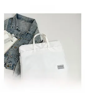 Detail of a white waterproof nylon laptop bag with fashion webbing and sturdy handles