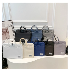 Waterproof multi-color laptop bags displayed in a minimalist studio setting with handle details