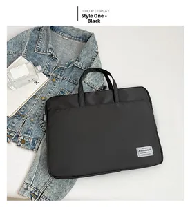 Close-up of black waterproof laptop bag with high-density fabric and metal brand logo