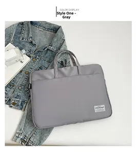 Detail of grey high-density nylon laptop bag with durable handles and fashion labels