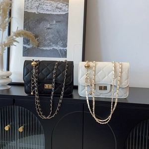Classic quilted chain shoulder bag in black and ivory with adjustable gold ball strap