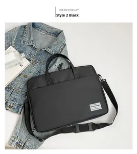 Flat lay of a large black waterproof business tote bag with a padded shoulder strap