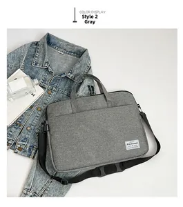 Detail of gray large-capacity laptop bag showing Oxford fabric texture and shoulder strap