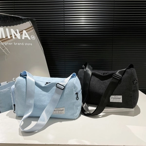 Japanese style canvas cylinder crossbody bags in light blue and black with adjustable straps