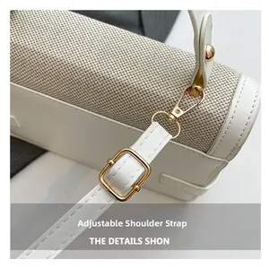 Detail of adjustable shoulder strap with gold metal hooks on cream canvas handbag