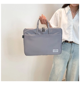 Detail of durable grey fabric tote bag with comfortable handle and smooth double zippers