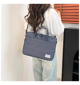 Rear view of a minimalist blue-grey laptop briefcase with top handles and shoulder strap