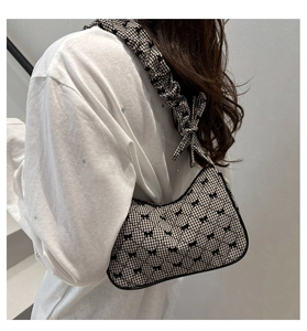 Shoulder bag with black and white plaid pattern and stylish ruffled drawstring strap