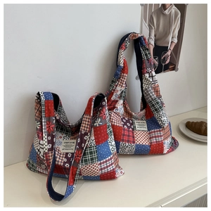 Detailed patchwork texture on a canvas tote bag with floral and plaid fabric patterns