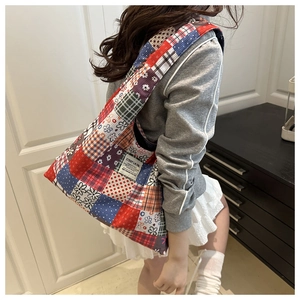 Detail of vintage patchwork tote bag with colorful patterns and C'EST LA VIE label