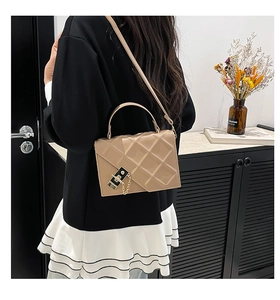 Chic beige quilted crossbody bag with diamond patterns and stylish black buckle detail